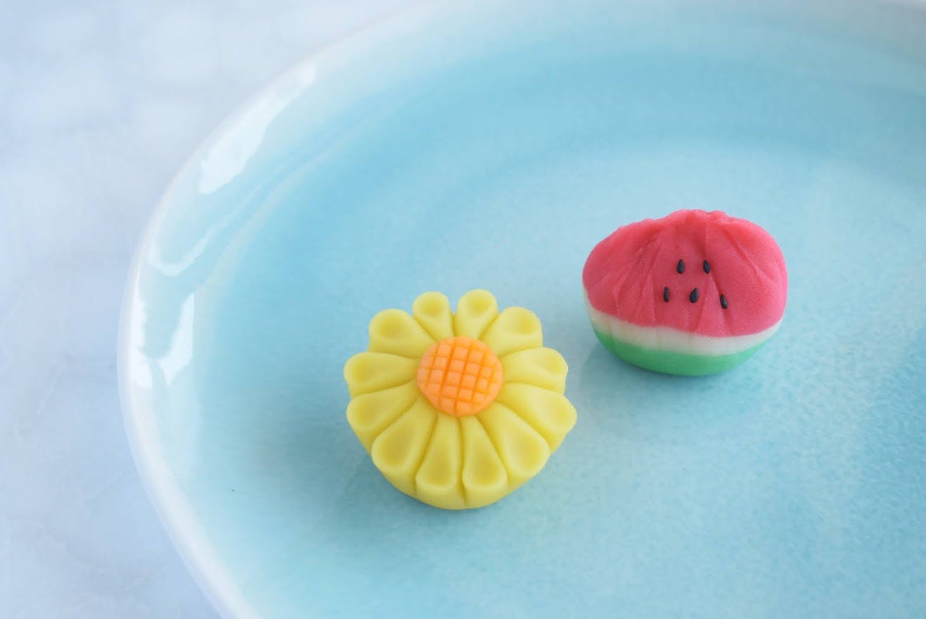 Image of two Japanese sweets shaped like a watermelon and sunflower.
