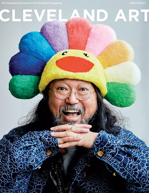 man smiling in colorful flower hat