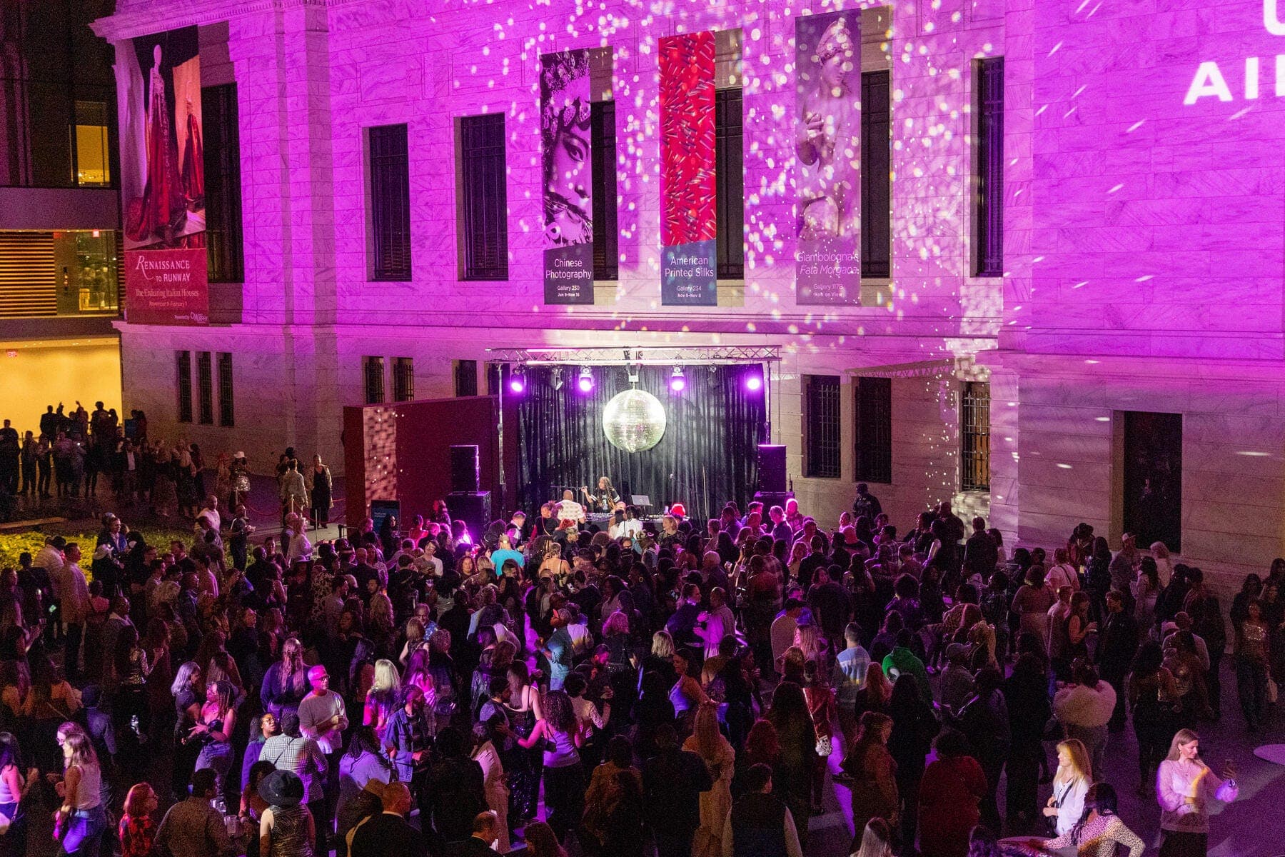 a large crowd of people in front of a stage