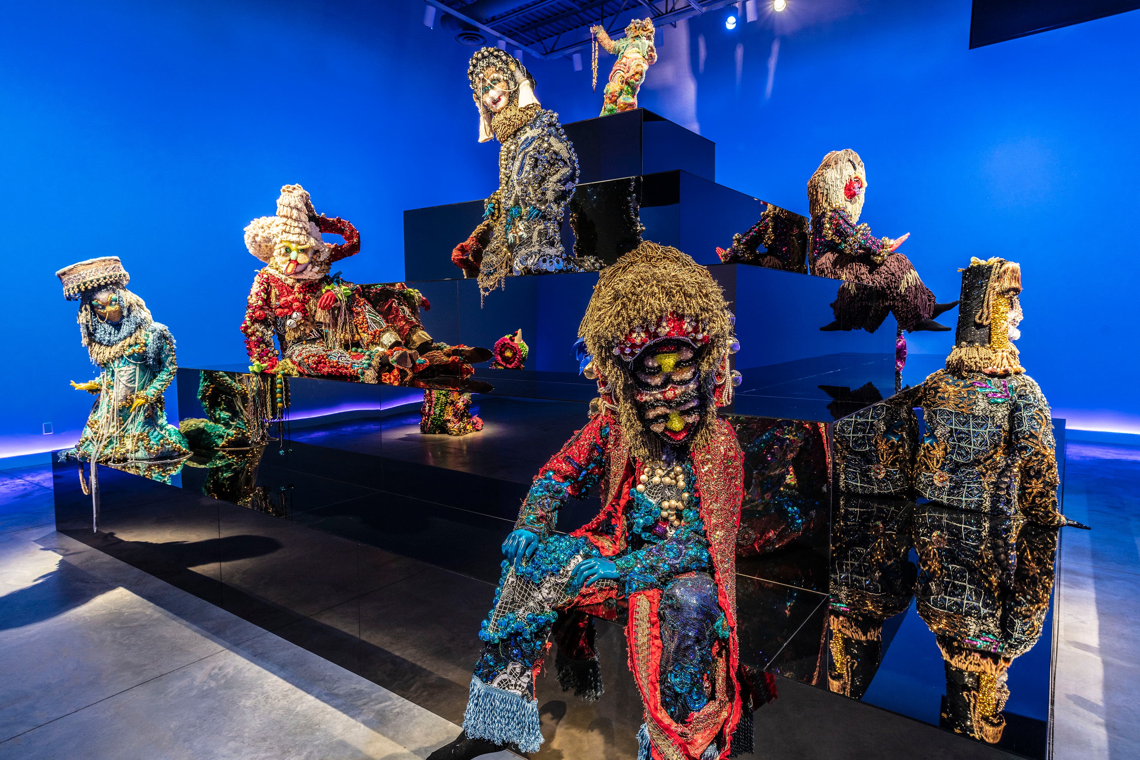 Installation of several highly decorative figures on a platform