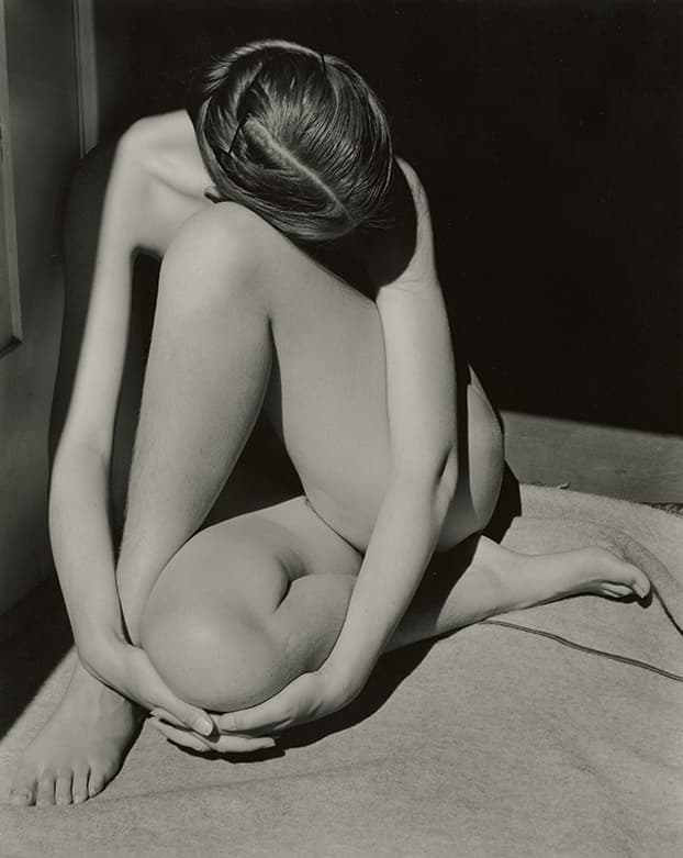 nude woman sitting down