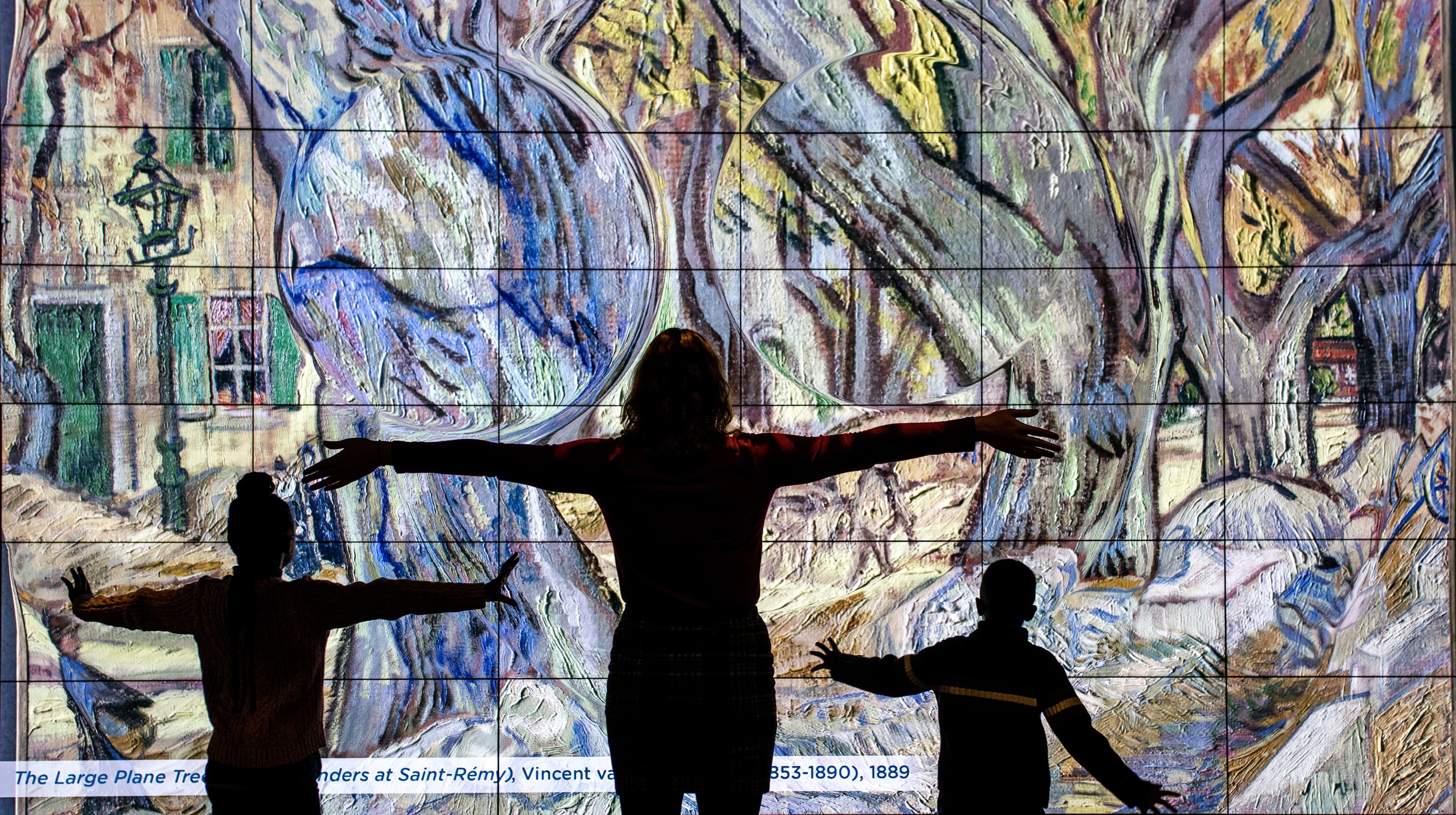 a person and a boy sitting at a table with a board game