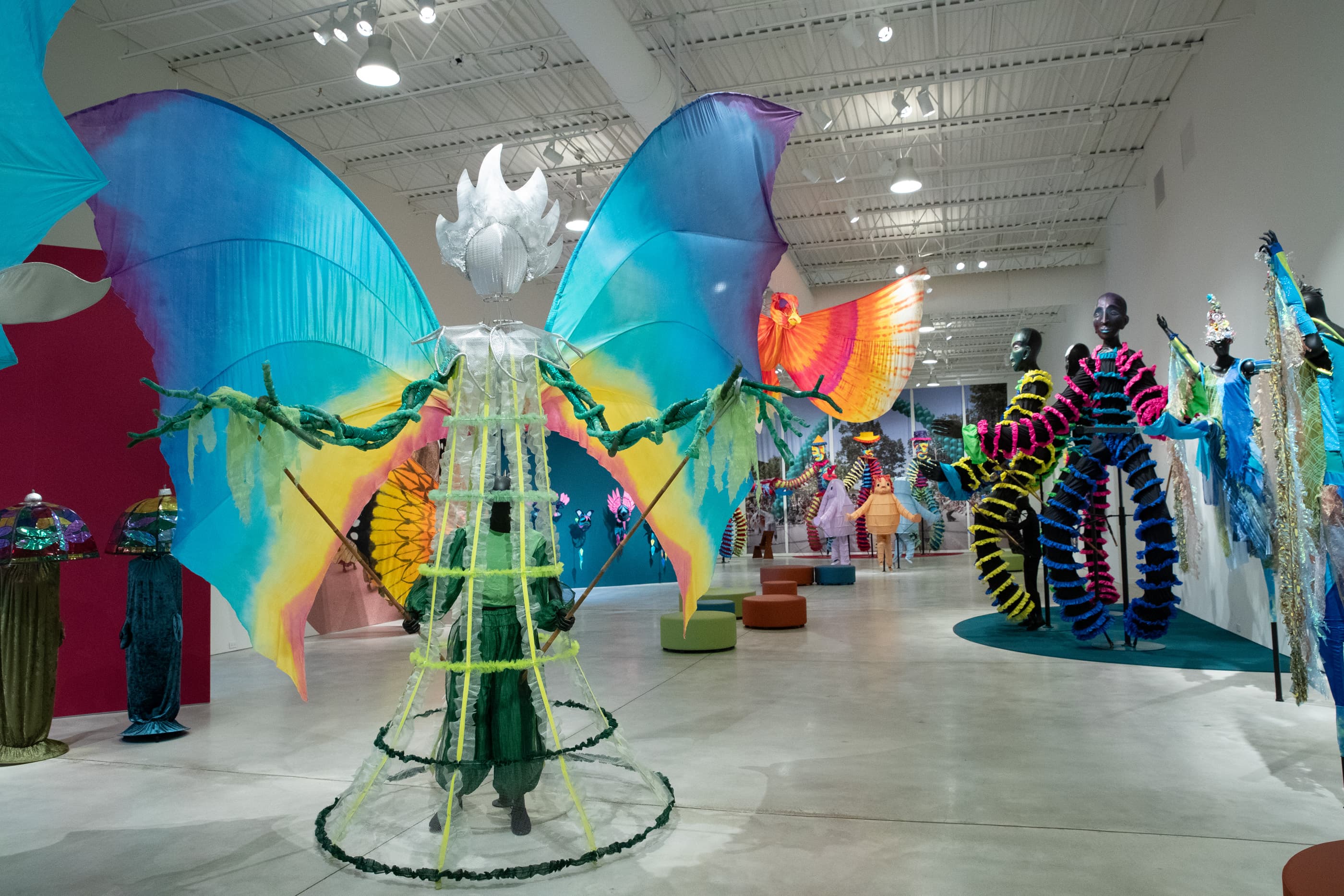 Large costumes from Parade the Circle displayed in a gallery.