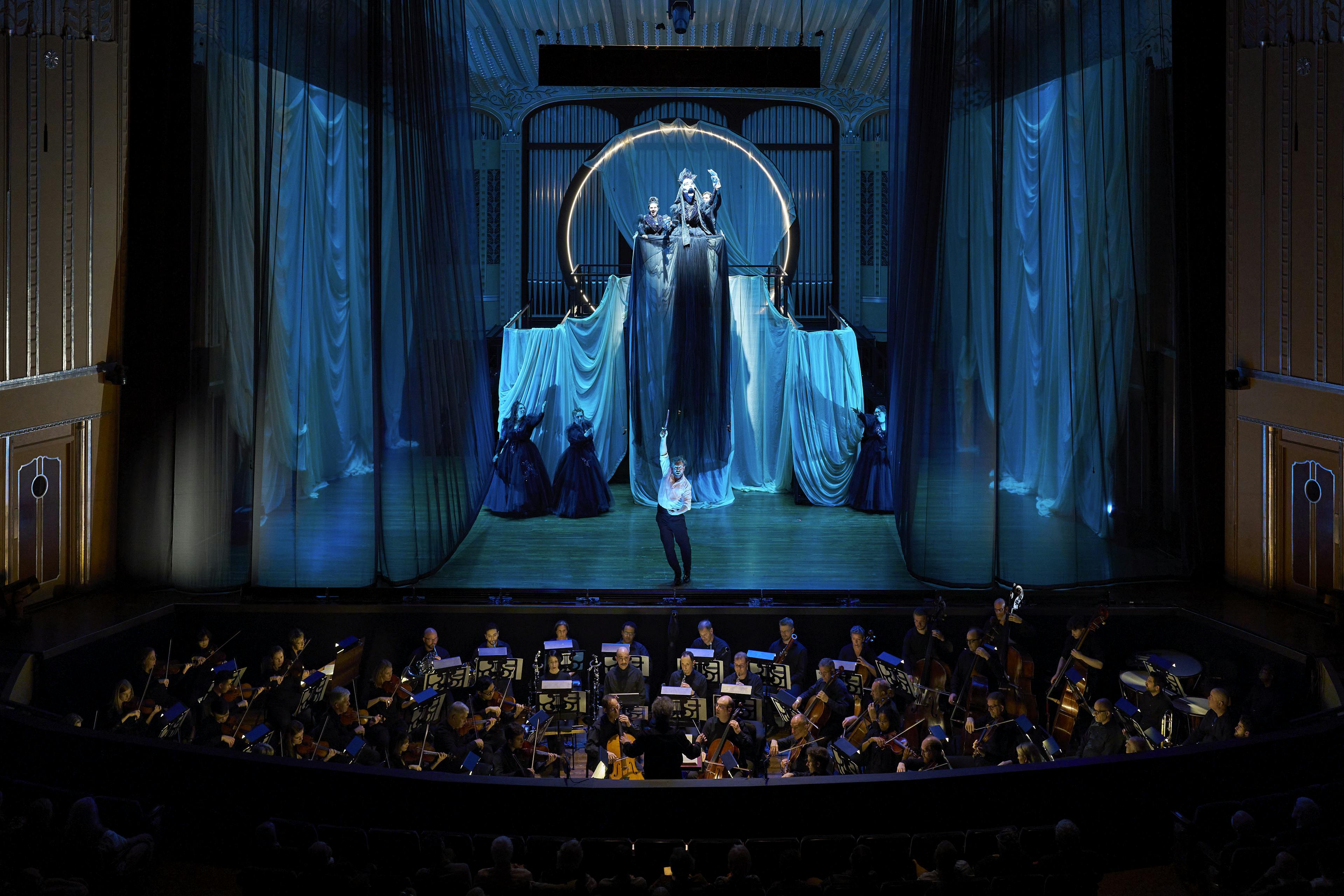 Stage with performers and an orchestra
