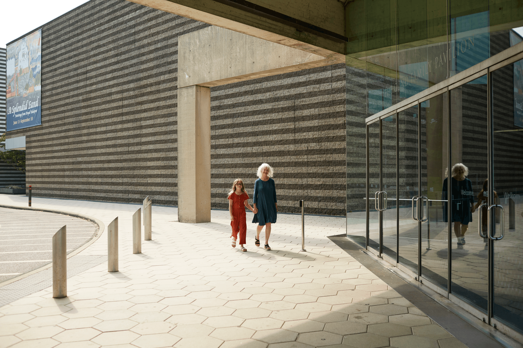 a couple of women walking outside of a building
