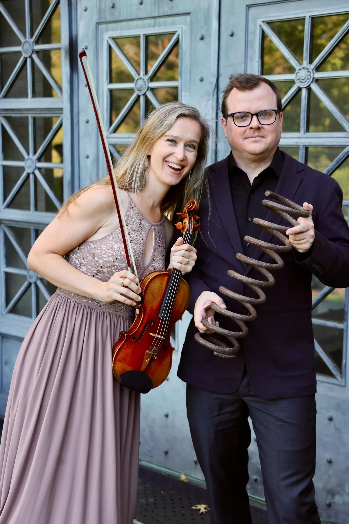 a man and woman holding a guitar