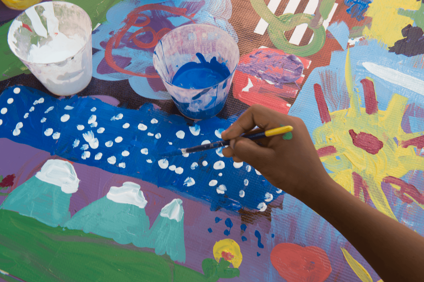 The hand of a child painting.