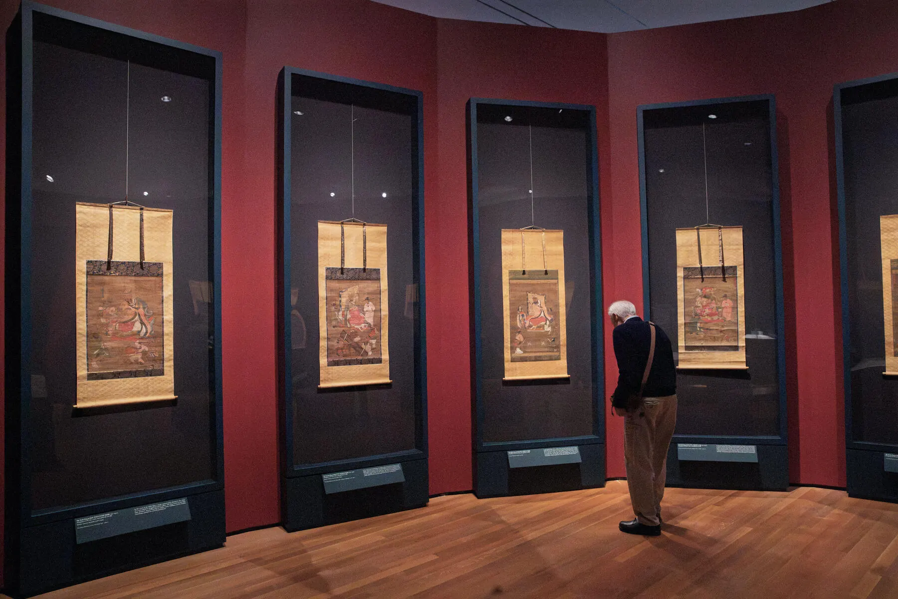 a person looking at a display of art