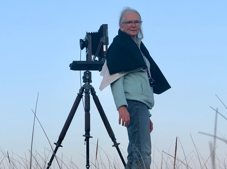 photographer standing next to her camera