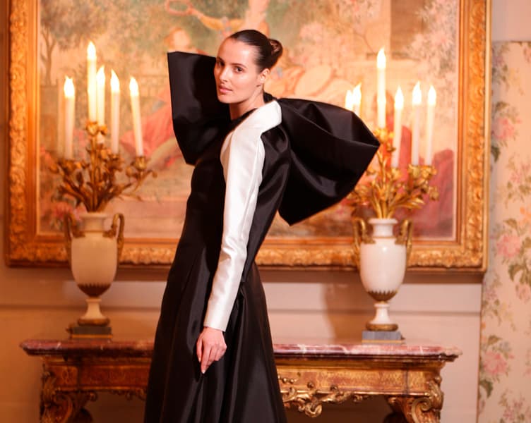 A model looking over her left shoulder wearing a stunning evening gown
